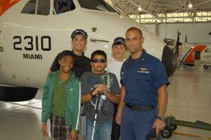 Coast Guard member Heredia with students.
