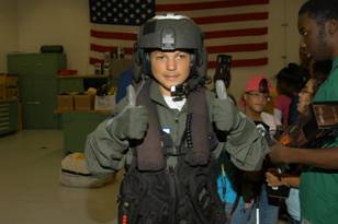 Miami Lighthouse summer camp student gives the �all is a go� dressed in Coast Guard gear.