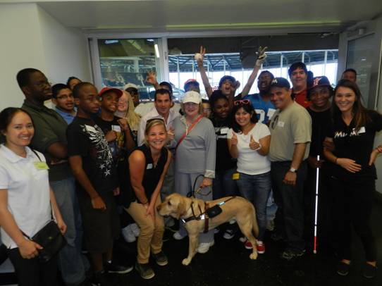 Miami Marlins President, David Samson and CEO of Miami Lighthouse Virginia Jacko celebrate the Marlins victory with summer program students and staff.