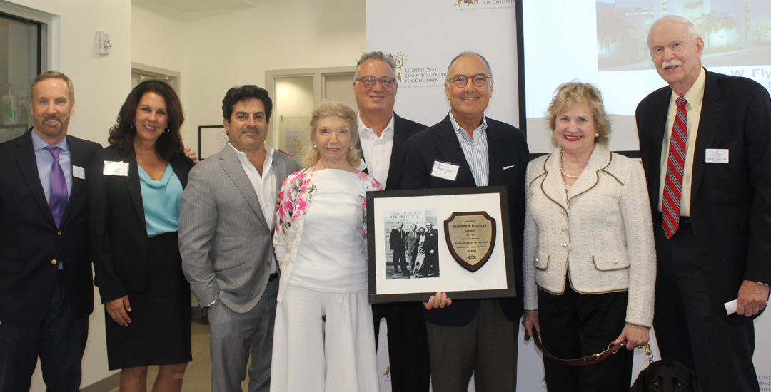 2018 Bascom Palmer Eye Institute Ophthalmologists Annual Receptions at Miami Lighthouse: Miami Lighthouse Board Directors Dr. Thomas Johnson, Donna Abood, Alfred Karram, Angela Whitman, Louis Nostro, President and CEO Virginia Jacko and Dr. Harry Flynn present tribute of original photo of Bascom Palmer Eye Institute building groundbreaking to BPEI Chair Dr. Eduardo Alfonso.