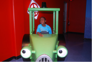 Child rides in a train learning about the different modes of transportation.
