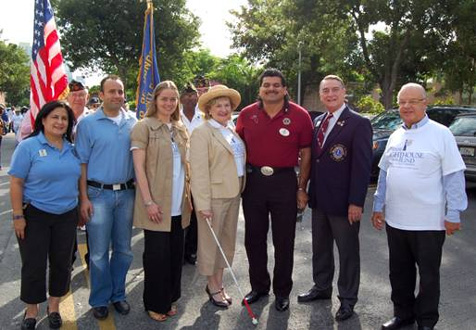 District 35N Vice Governor Lion Diana Castillo, Amerigroup representative Stephen Roca, Miami-Dade County Mayors Office Suzanne Salichs, President and CEO Virginia Jacko, District 35N Governor Lion Alec Hernandez, District 35N Vice Governor Lion Juan Tejada, and Standard Chartered Bank and Board Director John Harriman