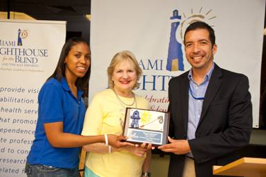 Kathryn Martinez and Socrates Aguayo representing Amerigroup Community Care, White Cane Day Signature Sponsor, with CEO Virginia Jacko