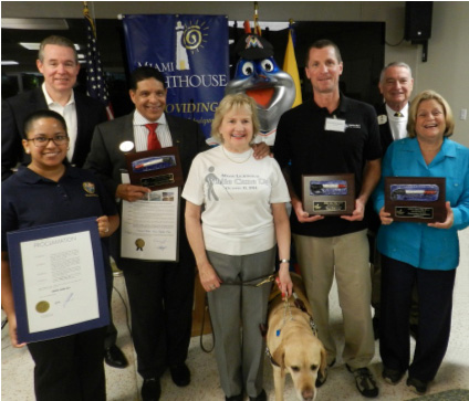 Emcee John Morales, Virginia Morgan representing Representative David Richardson, LtCol Tony Colmenares, Virginia Jacko, President & CEO, Billy the Marlin, Dave Hagemann, Lion Juan Tejera and Congresswoman Ileana Ros-Lehtinen.