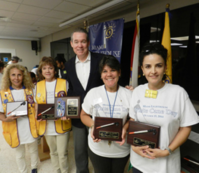 Lion Maria Augusta Pusey, Miami Five Star Lions Club, Lion Betty Barrera, Miami Lautaro Lions Club, emcee John Morales, NBC 6 Miami, Lion Nelba Gonzalez, Coordinator of Arts and Crafts/SGA, Susie Wahab.