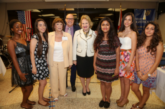 Senator Gwen Margolis, Representative David Richardson, President & CEO Virginia Jacko and Miami Lighthouse Music Program participants