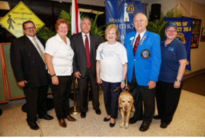 Juan Carlos Diaz, DBS District Administrator, Commissioner Sally Heyman, Board Chair Ramon Casas, CEO Virginia Jacko, Lion Ildefonso Oretega and Penny Shaffer.