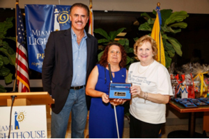 Emcee Ron Magill, Denise Valkema of Miami National Federation of the Blind and CEO Virginia Jacko