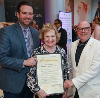 Representatives Jose Felix Diaz and David Richardson present President & CEO Virginia Jacko with proclamation