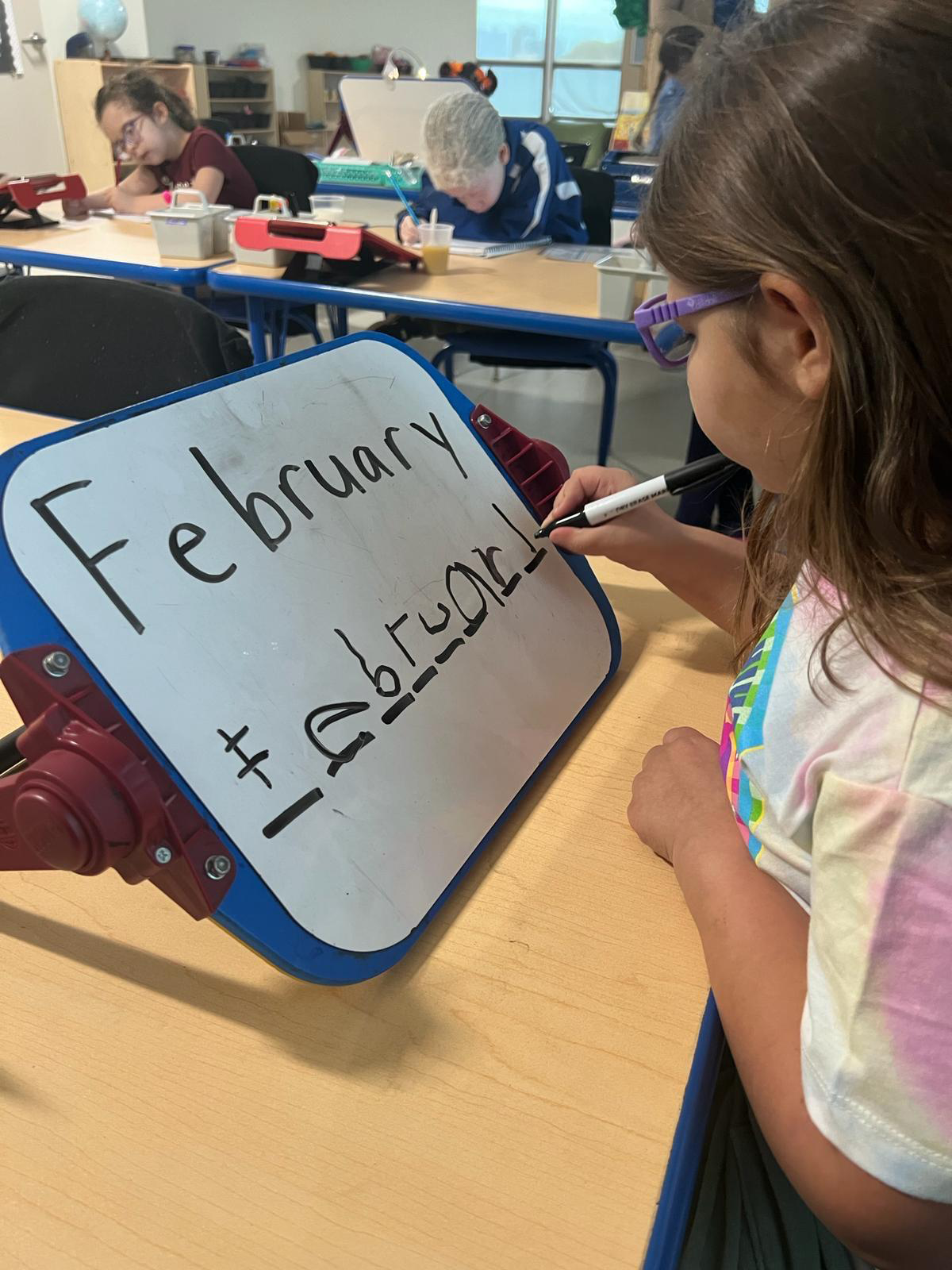 Aimee using a slant board during Phonics