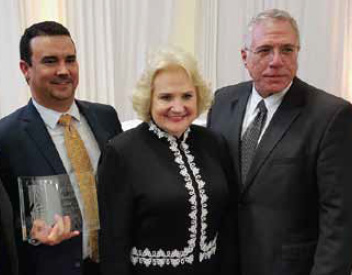 Miami Lighthouse Chairman Ray Casas, right, and President and CEO Virginia Jacko receive the award from Joe Jimenez, vice president for legal and regulatory affairs of the sponsoring Codina.