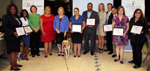 Legislative aides accept recognition plaques (from left to right) Mary Cowart aide to Representative Cynthia Stafford, Ludie Benel intern to Representative Dwight Bullard, Julie Fishman aide to Senator Nan Rich, Lissette Vasquez aide to Senator Anitere Flores, CEO Virginia Jacko, Raquel Zuniga aide to Representative Ana Rivas Logan, George Fossett aide to Representative Matt Hudson, Holly Merrill Raschein aide to Representative Ron Saunders, Matt Monica aide to Representative Luis Garcia, Tore Ciolino aide to Representative Franklin Sands, Harriet Carter Community Liaison to U.S. Congresswoman Ileana Ros-Lehtinen and Laurie Flink Deputy District Director to U.S. Congresswoman Debbie Wasserman Schultz.