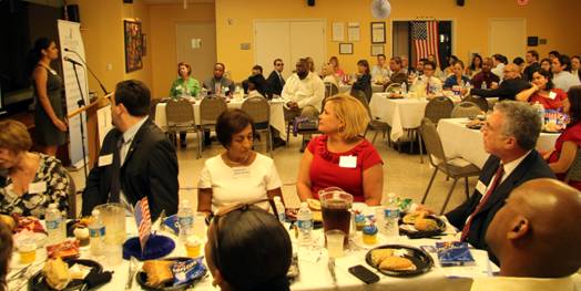 Attendees enjoy God Bless the U.S.A sung by Natalia Sulca.